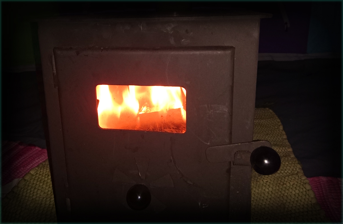 Burning stove inside bell tent