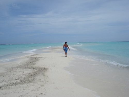 Walking down a sand back in the Maldives